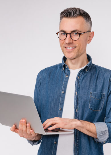 Hombre con lentes sosteniendo un computador con sus manos